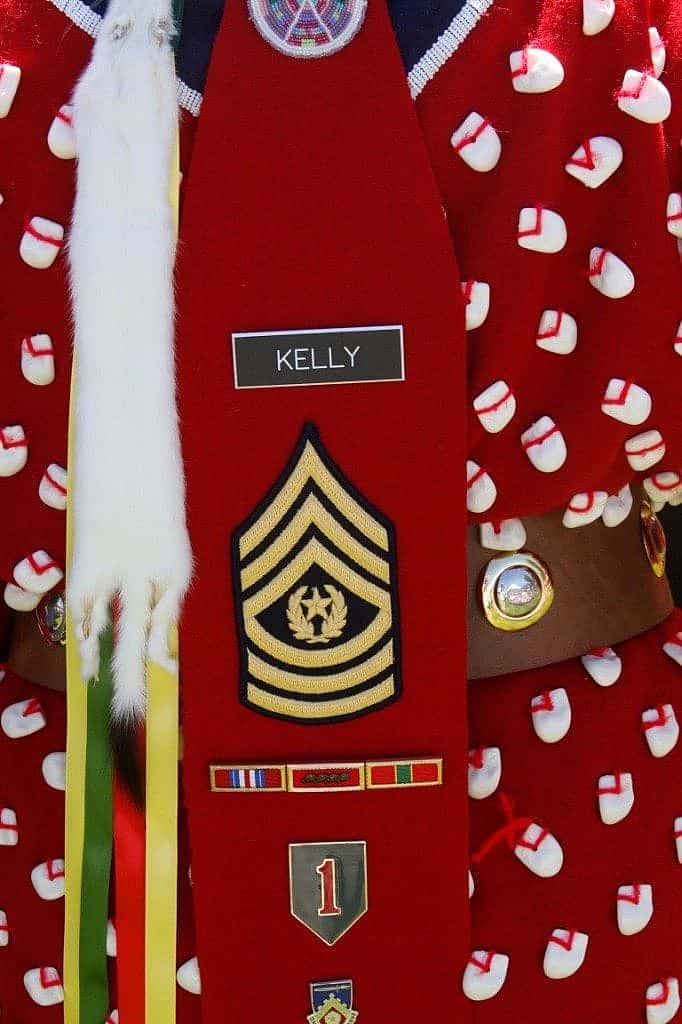 The Apsaaloooke Nation Color Guard's female veteran incorporates military regalia with traditional dress.