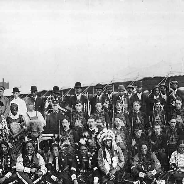 Large group of people, some with musical instruments.