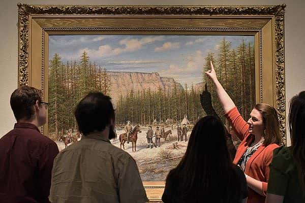 ET-Kirsten-BBM-WWAM-web Exclusive Tours guide Kirsten shows a painting in the Buffalo Bill Museum.
