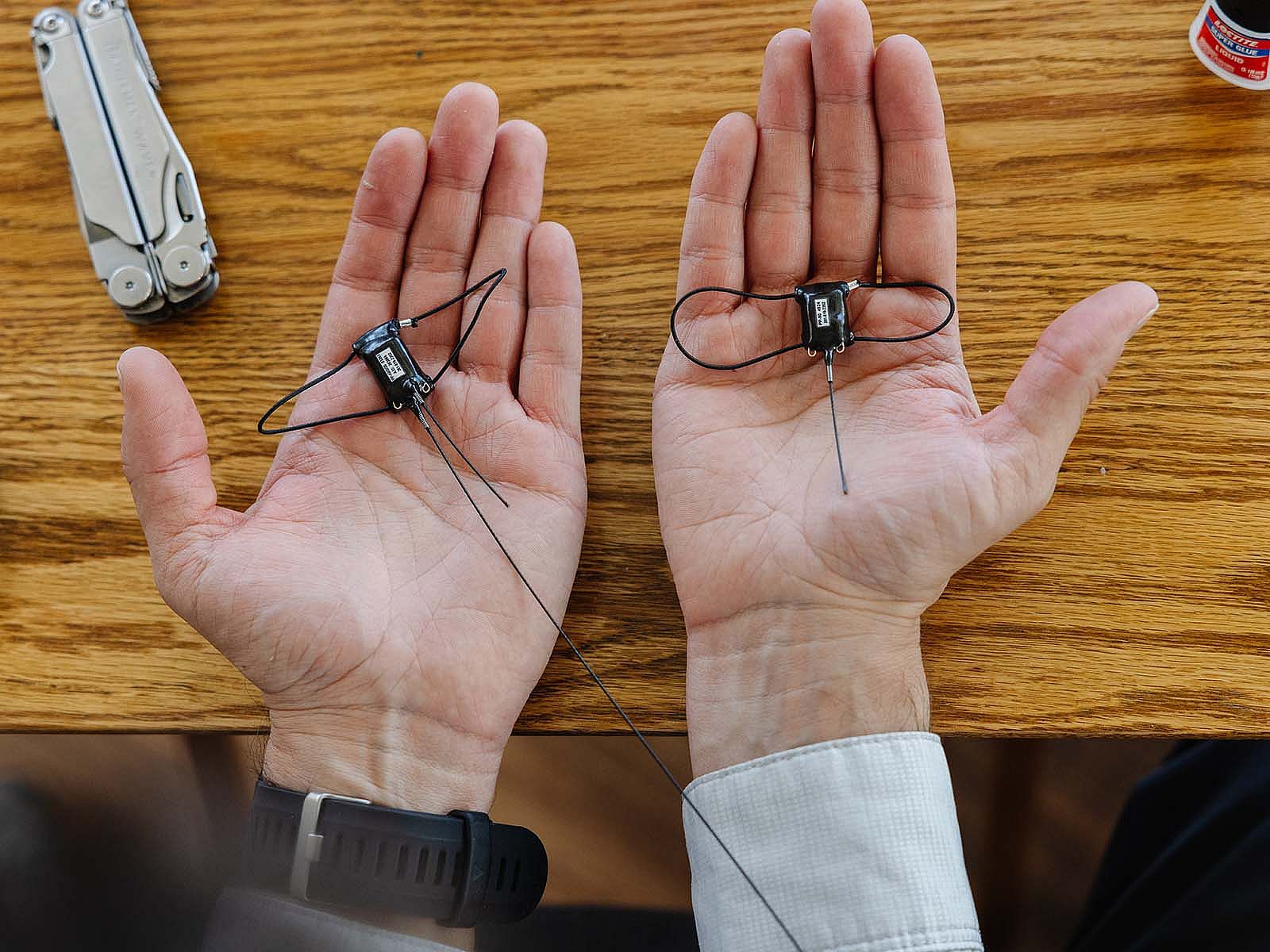 GPS tags shown in outstretched palms.