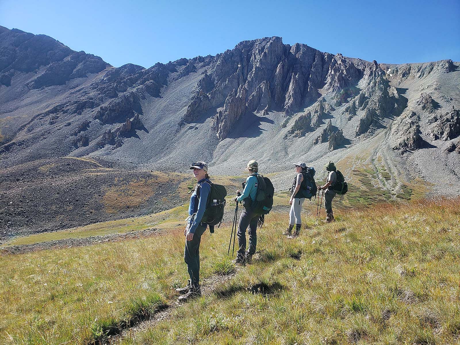 Four researchers for the Absaroka Bat Census hike single file on a single track.