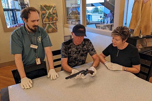 ET-DepotRevolver-web Exclusive Tours guide Nick shows a revolver to two tour participants.