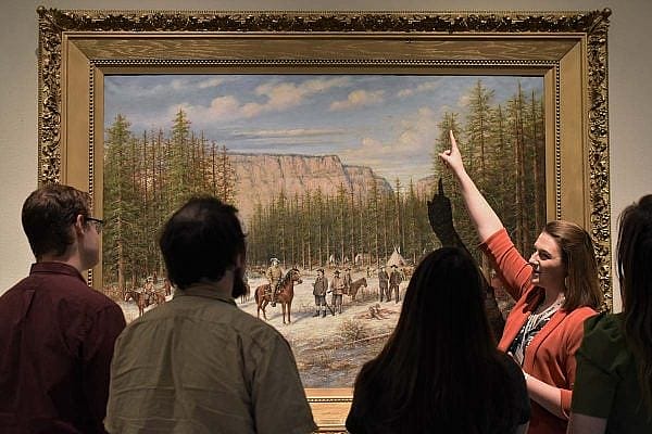 ET-Kirsten-BBM-WWAM-web Exclusive Tours guide Kirsten shows a painting in the Buffalo Bill Museum.