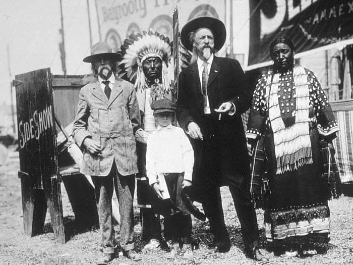 E.S. Paxson, W.F. Cody with others unidentified, backstage of Wild West show, c. 1914. P.648.36