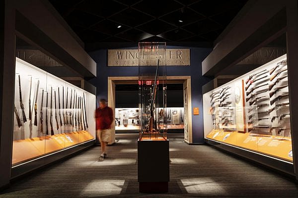 A visitor walks along the Cody Firearms Museum, a popular gun museum in Cody, WY.
