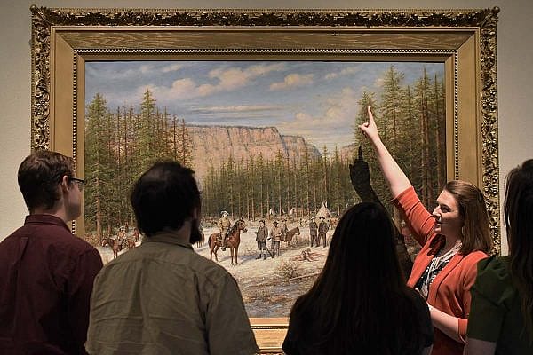 ET-Kirsten-BBM-WWAM-web Exclusive Tours guide Kirsten shows a painting in the Buffalo Bill Museum.