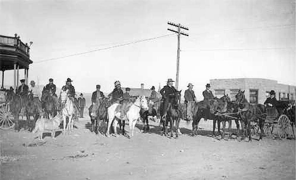 Buffalo Bill and his so-called "posse" - actually his hunting guests - in 1904, congregating in front of the Irma Hotel (left) with the First National Bank in the background. Courtesy Wyoming State Archives, State Parks and Cultural Resources. King Neg #596