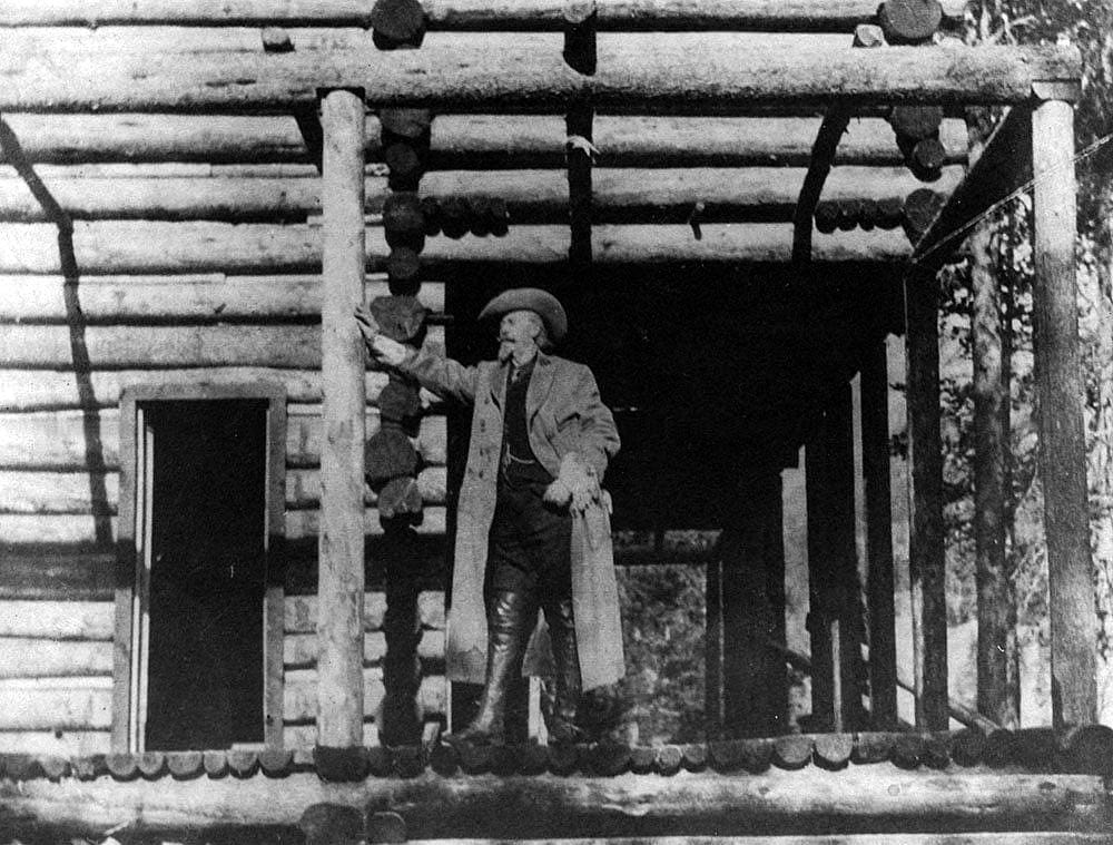 Buffalo Bill standing on porch at Pahaska Tepee, ca. 1905. Black and white photograph. MS 6 William F. Cody Collection. P.69.286