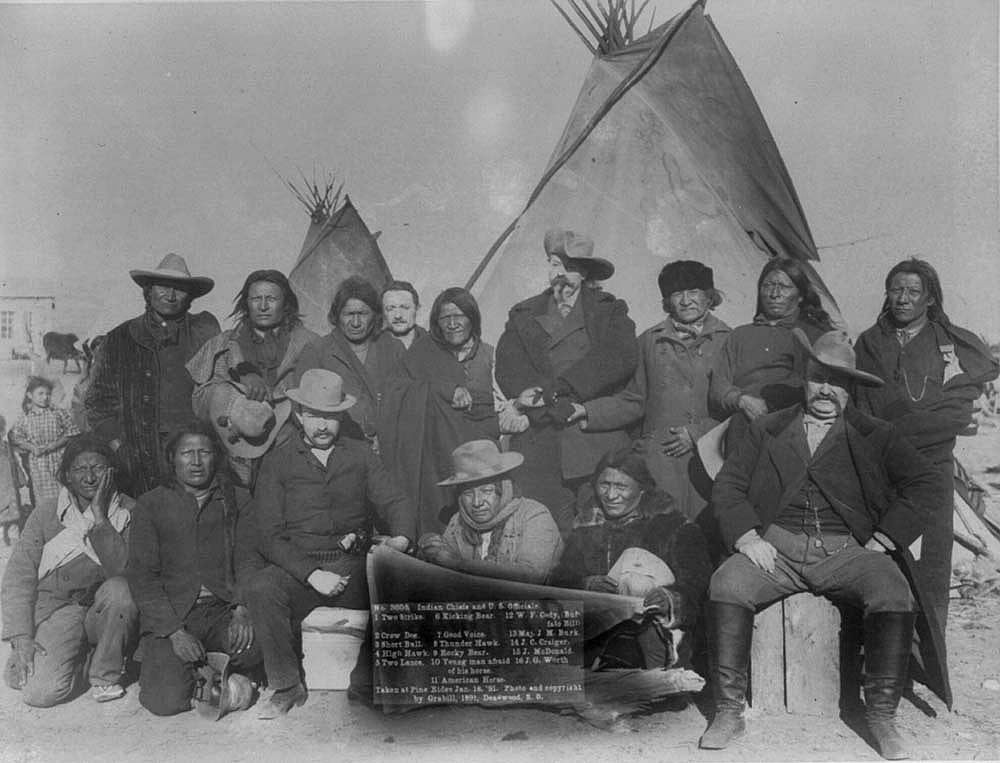 According to the sign, these are "Indian chiefs and U.S. officials" meeting at Pine Ridge, South Dakota, January 16, 1891, not quite a month after Wounded Knee. Included are Buffalo Bill, center back, and Major Burke, seated front right, no doubt weighing in on the recent events. Library of Congress Prints and Photographs Division, Washington, D.C. 20540 USA. LC-USZ62-2468