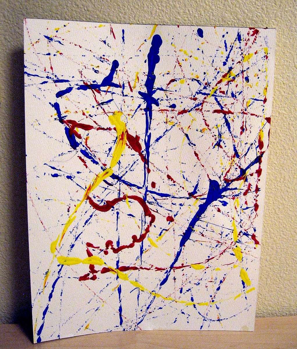 Abstract splatter painting made by a child using red, blue, and yellow paint during an arts and crafts activity at the Buffalo Bill Center’s Family Fun Day.