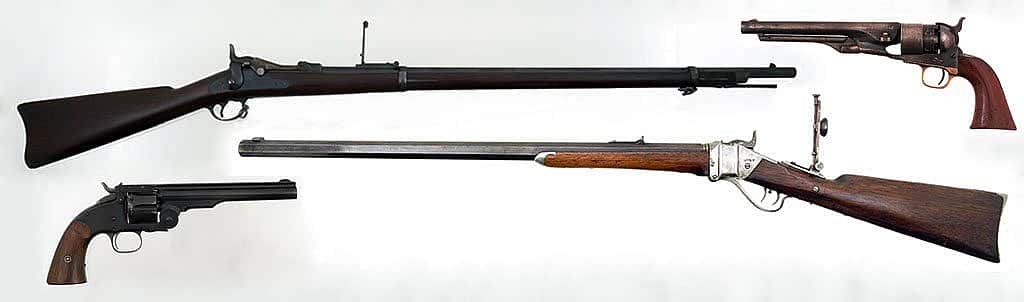 "Cinematically unpopular" favorite firearms of the American West. Clockwise, from top left: M1873 trapdoor Springfield rifle, Gift of Olin Corporation, Winchester Arms Collection, 1988.8.754; M1860 Colt Army revolver, on loan from F.T. Bucholz Collection, L.1.95.11; M1874 Sharps Rifle, Gift of H. Bill Newton, 1990.10.1; and Smith and Wesson Schofield revolver, Gift of the Olin Corporation, Winchester Arms Collection. 1988.8.2534