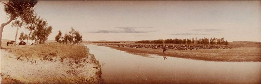 "Hot noon beside the roundup camp. Big Dry, Montana." L.A. Huffman's willingness to carry his large glass plate camera with him allowed him to capture aspects of cowboy life on the open range. This contact print, colorized by Huffman, is part of his studio collection. MS 100 L.A. Huffman Collection. P.100.3626