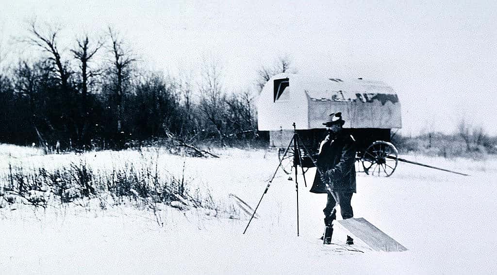 Sharp sets up an easel to paint the winter landscape, ca. 1905. On the Crow Agency, Sharp used an old sheepherder's wagon as a mobile painting studio. P.22.42