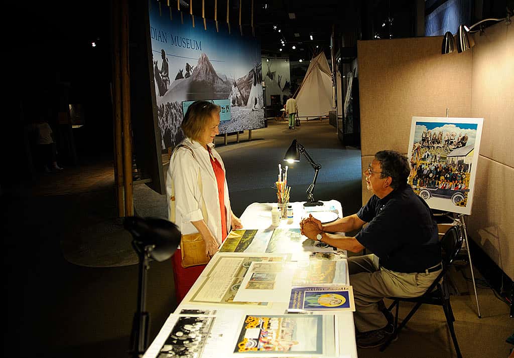 Arthur Amiotte demonstrating his work in the Plains Indian Museum gallery.