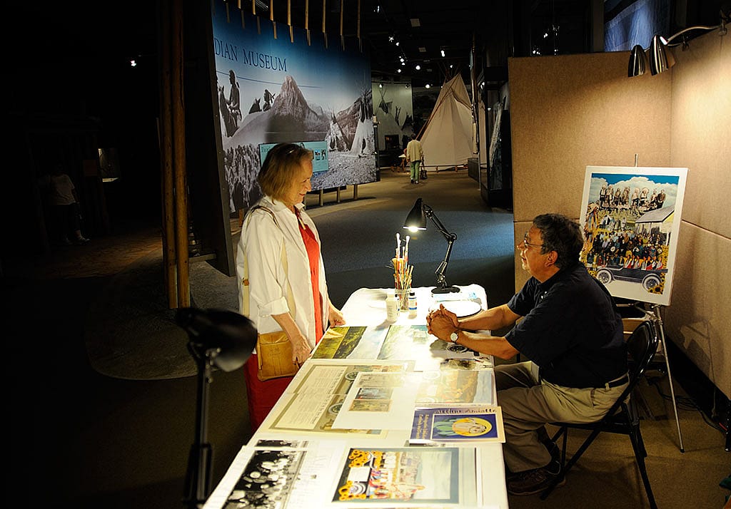 Arthur Amiotte demonstrating his work in the Plains Indian Museum gallery.