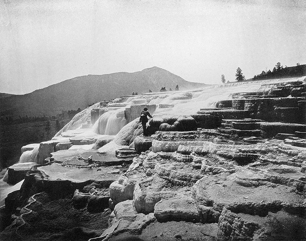 Hayden was certain that Jackson's photographs - like this one of artist Thomas Moran at White Mountain Hot Springs (today's Mammoth Hot Springs) - would sell Yellowstone. He simply needed an economical way to do it. WHJ-A.058