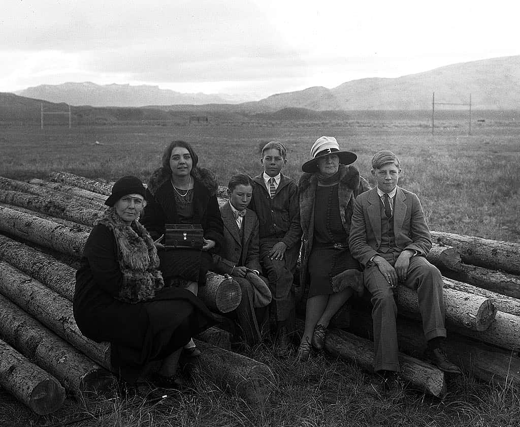 A Treasure from Our West: (L-R) Mary Jester Allen (1875-1960); Jane Garlow (1909-1987); George Walliker, the Garlow children's cousin; Bill Garlow (1913-1992); Geneva Garlow Walliker, Fred Garlow's sister and the Garlow children's aunt and caretaker; and Fred Garlow Jr. (1911-1985) sitting on logs at the construction site of the original Buffalo Bill Museum in downtown Cody, Wyoming. PN.228.146