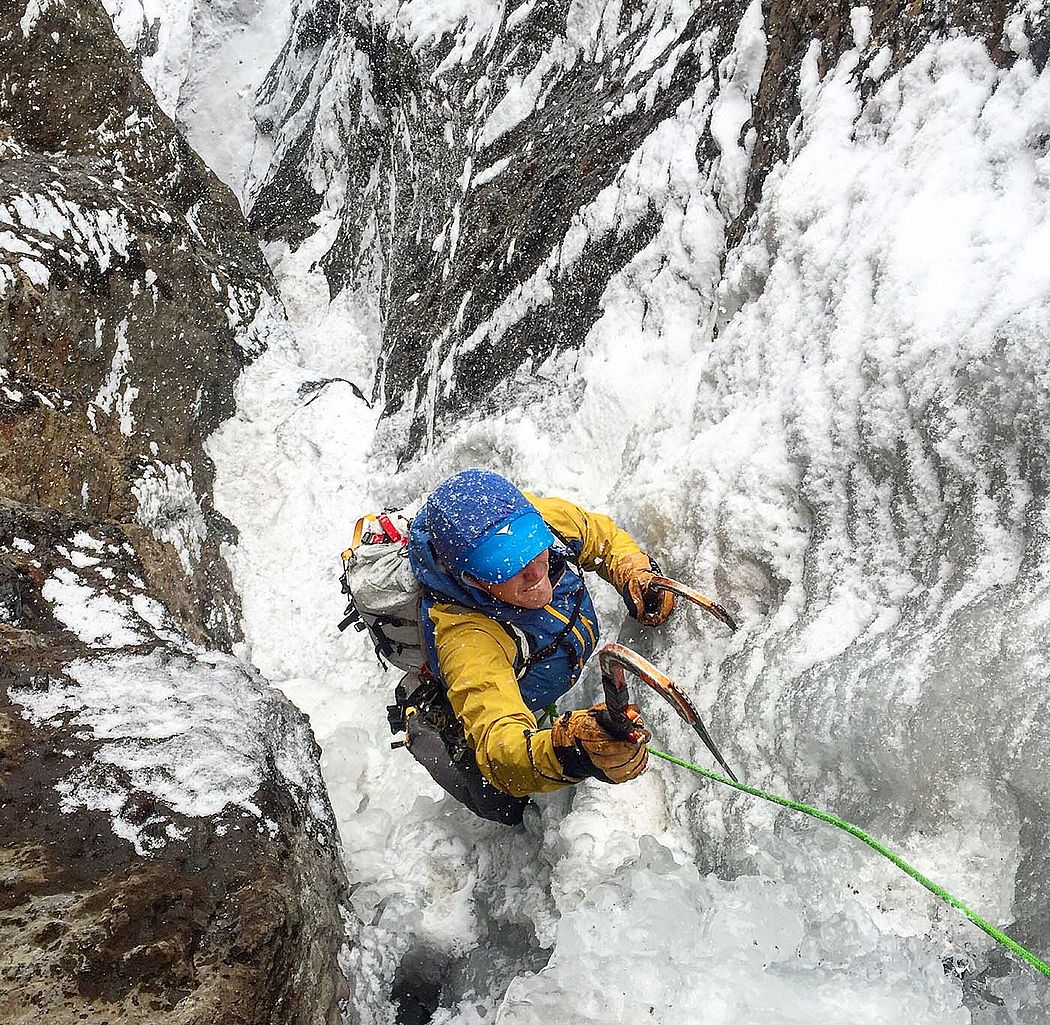 Fresh snow falls on Cody-based ice climber Chris Guyer as he squeezes through the "chimney" of a route known as Stringer. Aaron Mulkey photo.