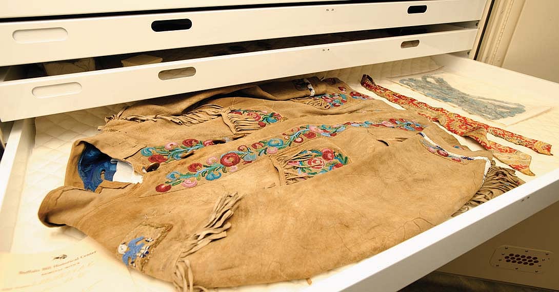 A jacket owned by William F. "Buffalo Bill" Cody in the Buffalo Bill Museum vault. Made of buckskin with brass buttons, beads, and silk satin, ca. 1898. Gift of Robert Garland. 1.69.784