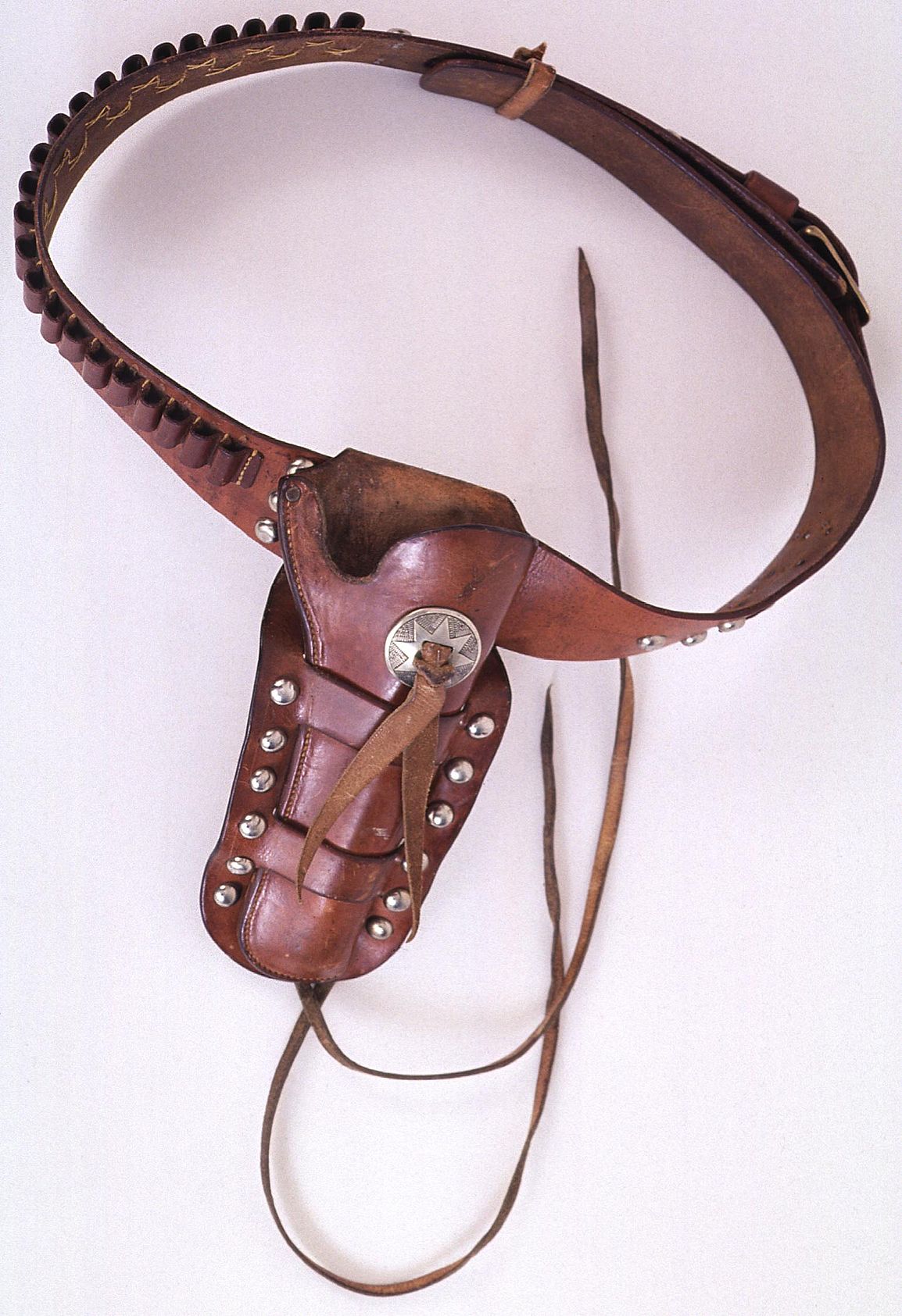 Cartridge belt and holster, ca. 1900. Abercrombie & Fitch. Gift of Irving H. "Larry" Larom. 1.69.735AB