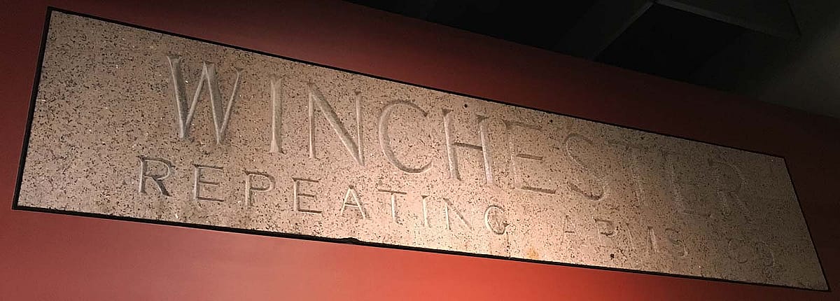 This granite lintel, now in the Cody Firearms Museum, once hung over the entrance to the Winchester Repeating Arms factory in New Haven, Connecticut.