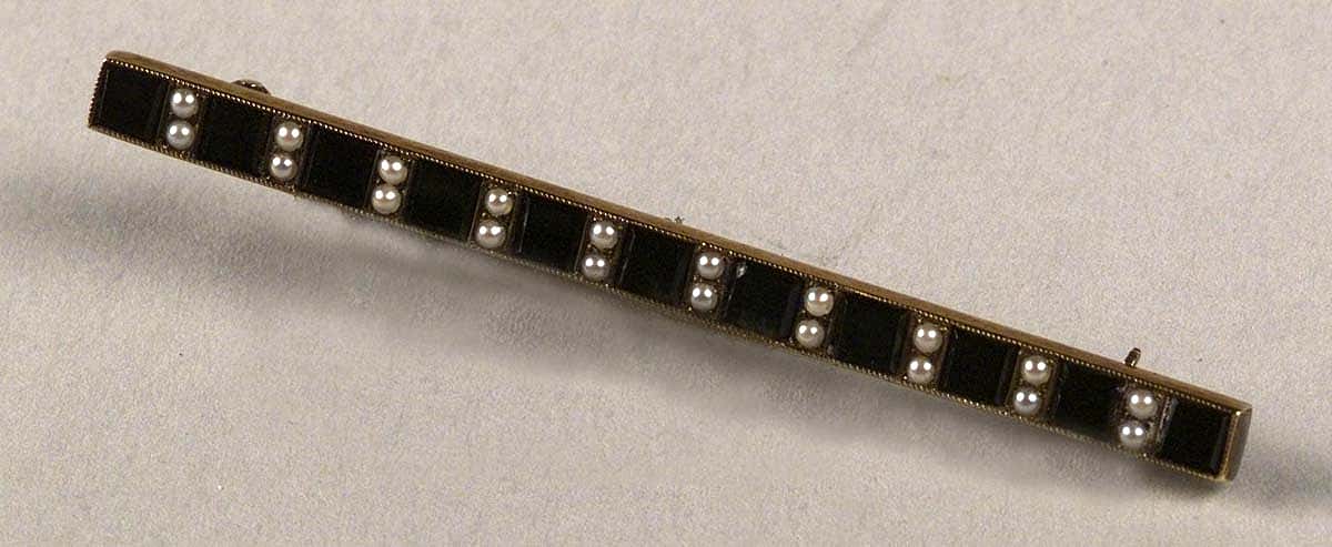 Gold bar pin set with pearls and onyx. Inscription on back: "Mrs. W.F. Cody, sponsor, S.S. Cody 6-19-20, from USSB employees, Hog Island, Pa." Museum purchase, Garlow Collection. 1.69.336