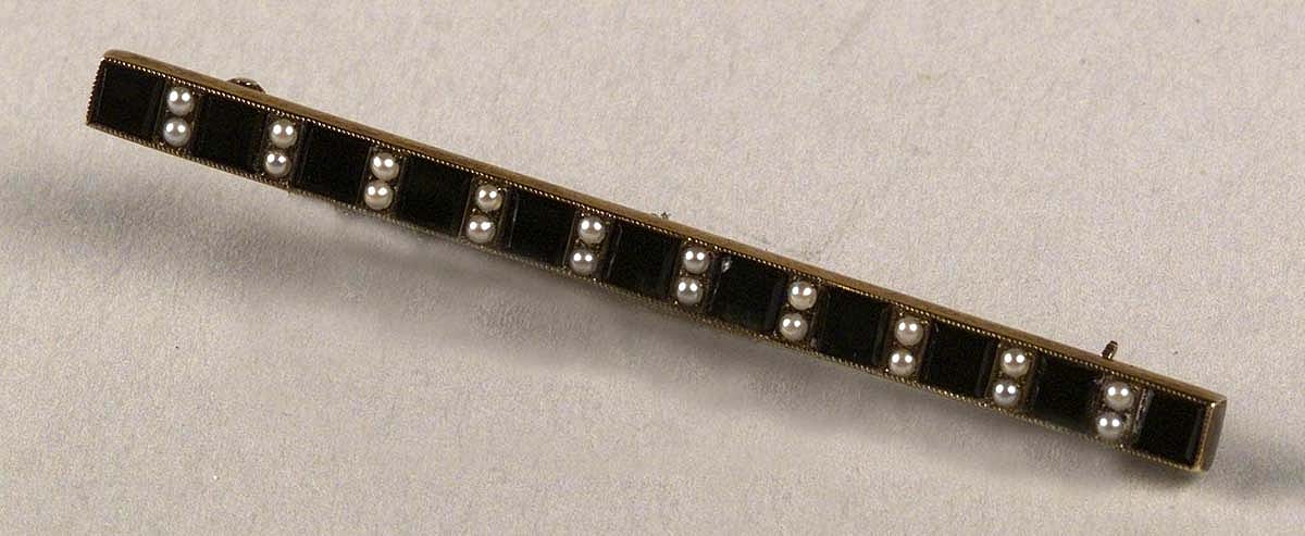 Gold bar pin set with pearls and onyx. Inscription on back: "Mrs. W.F. Cody, sponsor, S.S. Cody 6-19-20, from USSB employees, Hog Island, Pa." Museum purchase, Garlow Collection. 1.69.336