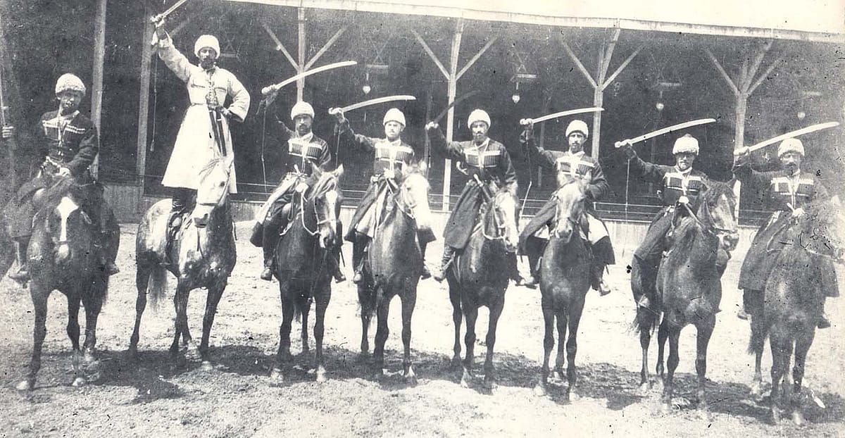 Georgian horsemen in England, circa 1903. Standing on the horse, in white chokha, Luka Chkhartishvili. Collection of Irakli Makharadze.