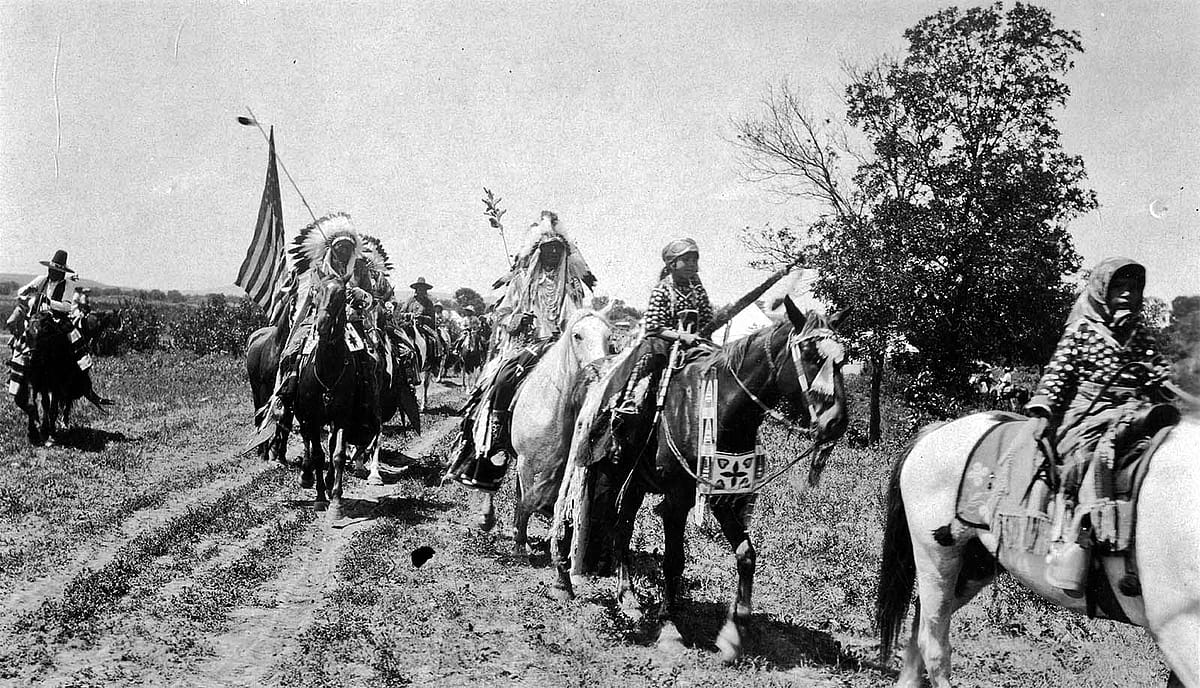 Horse and riders parading at Crow Fair, Crow Agency, Montana. Photo by W.H.D. Koerner, 1927. P.78.4452