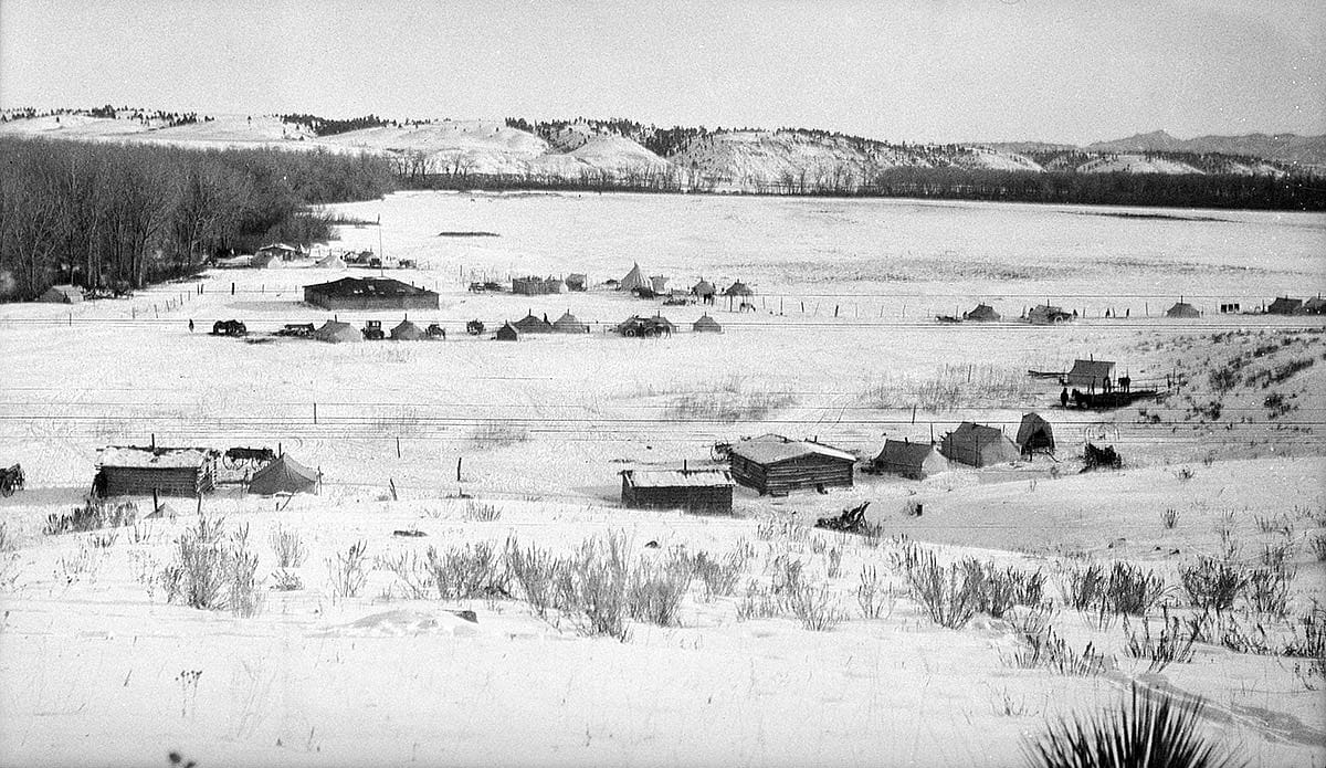 Log buildings and tents in winter, ca. 1922-1935. MS 165 Thomas B. Marquis Collection. PN.165.2.158