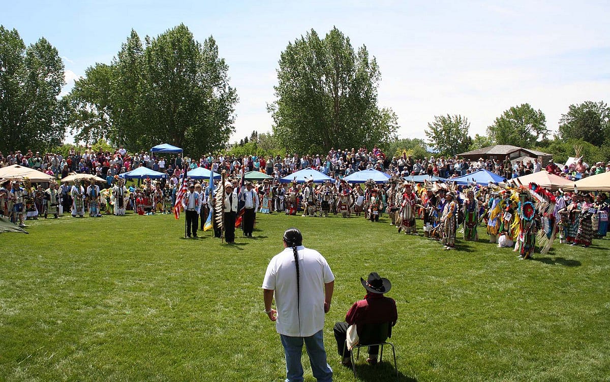 Joe Medicine Crow (seated) oversees the Grand Entry and presentation of the Color Guard at the 2011 Plains Indian Museum Powwow.