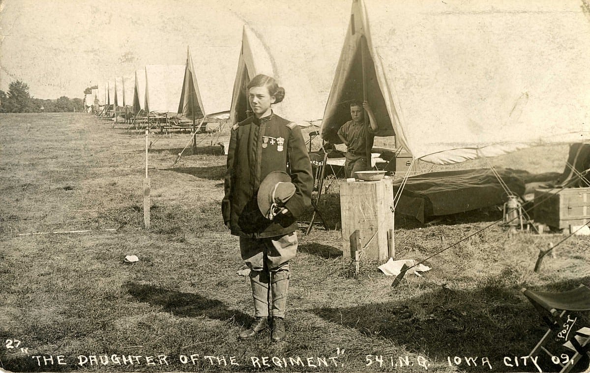 Cody Bell, with his hair in buns, at a National Guard encampment in 1909. MS 294 William A. Bell Family Collection, McCracken Research Library. P.294.0030