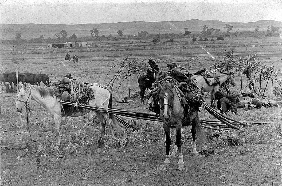 Crow people breaking camp; horses with travois, ca. 1880-1900. MS 35 North American Indian Photograph Collection. P.35.215