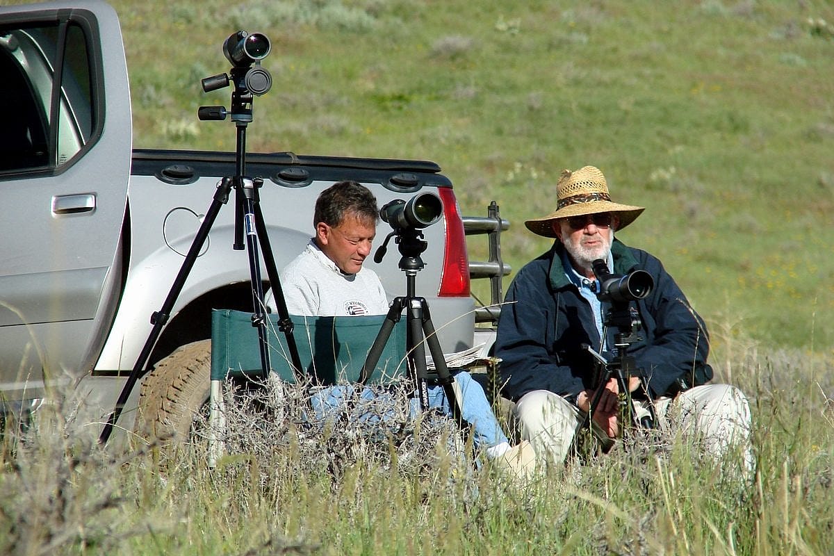 Posse members Richard Gruber (left) and Don Chaffey relax while monitoring their adopted nest from a distant observation post...more than 700 meters distant! This nest successfully fledged two eagles last week. Photo by A. Hay.