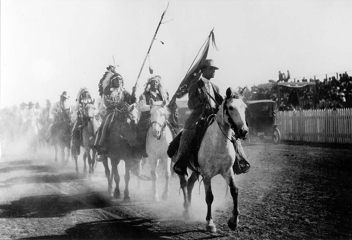 At the Park County Fair in 1913 (then hosted by the town of Cody), Wild West Arena Director Johnny Baker leads a parade in honor of the Prince of Monaco. Stampede exhibition photo.
