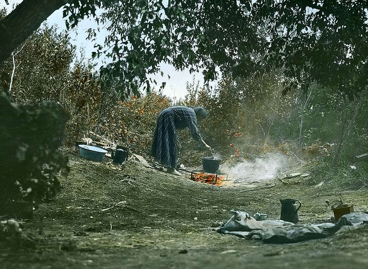 Crow woman cooking on campfire, ca. 1903-1925. MS 95 William A. Petzoldt Lantern Slide Collection. LS.95.319