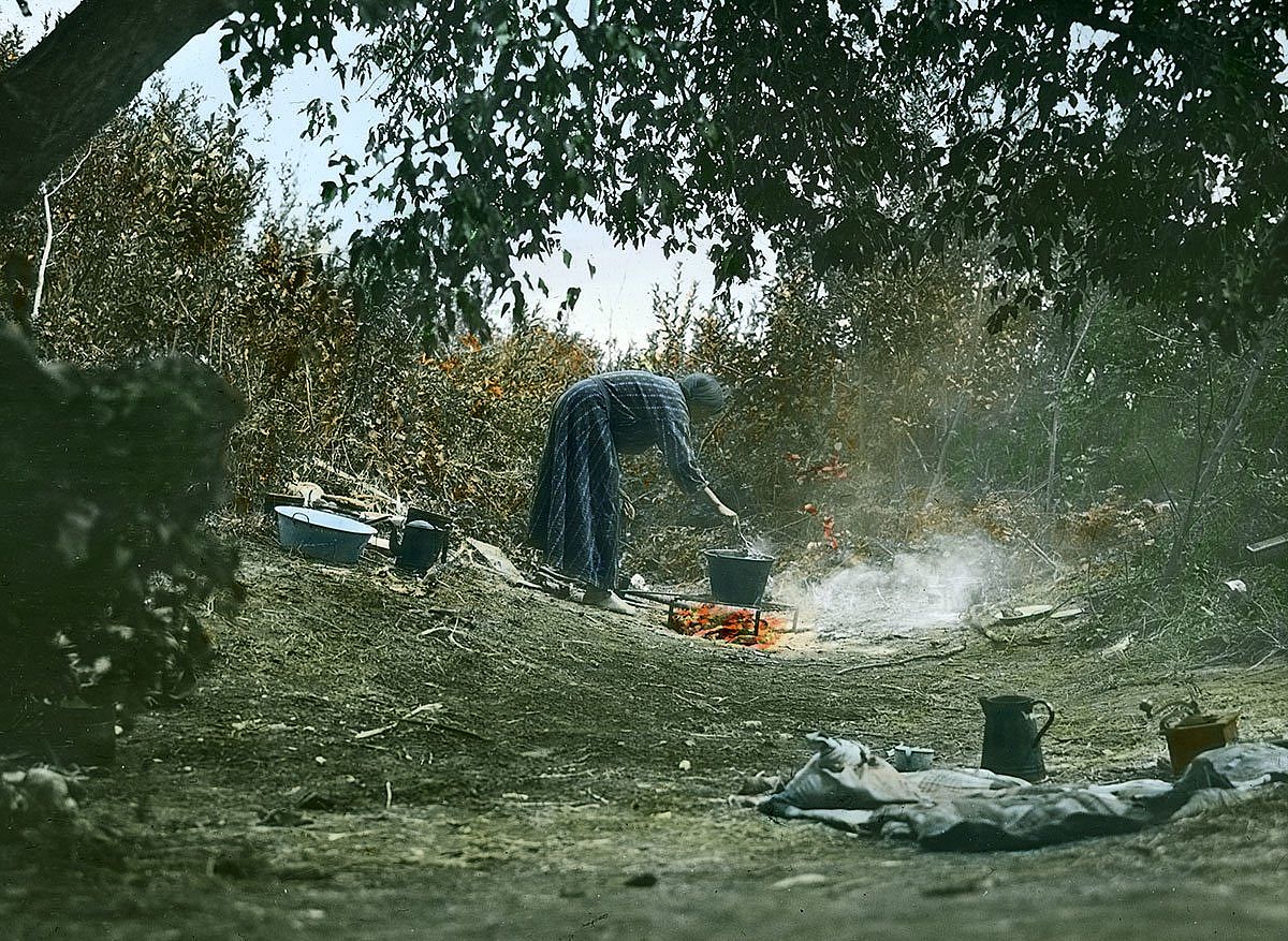 Crow woman cooking on campfire, ca. 1903-1925. MS 95 William A. Petzoldt Lantern Slide Collection. LS.95.319