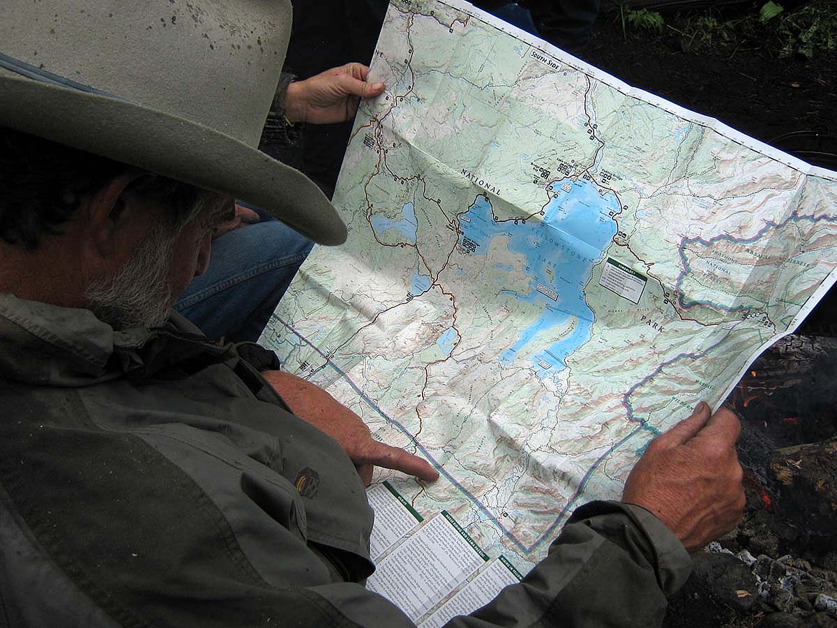 Consulting the map of the Thorofare region of Yellowstone.