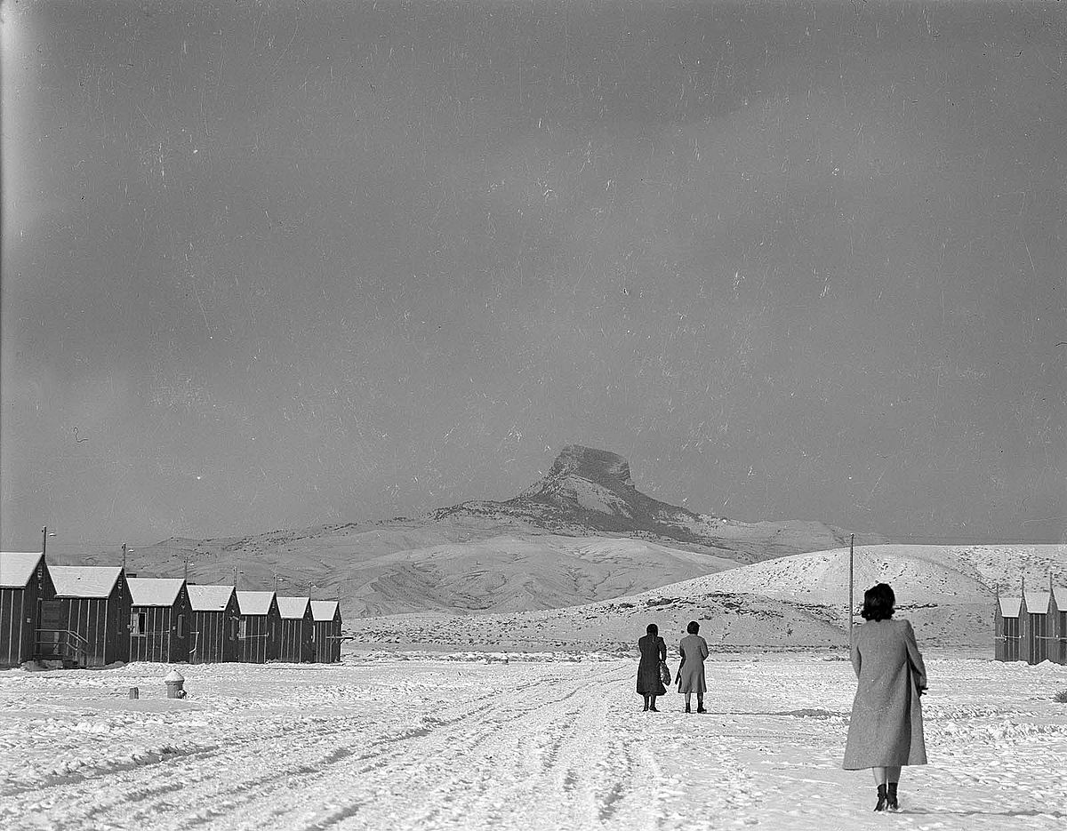 Japanese-American women walk to their barracks at Heart Mountain Relocation Center. MS 89 Jack Richard Photograph Collection, McCracken Research Library. PN.89.111.21238.3