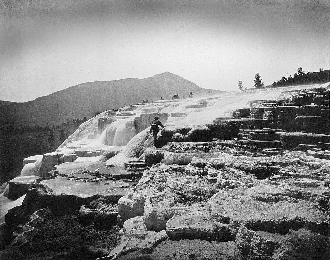Hayden was certain that Jackson's photographs - like this one of artist Thomas Moran at White Mountain Hot Springs (today's Mammoth Hot Springs) - would sell Yellowstone. He simply needed an economical way to do it. WHJ-A.058
