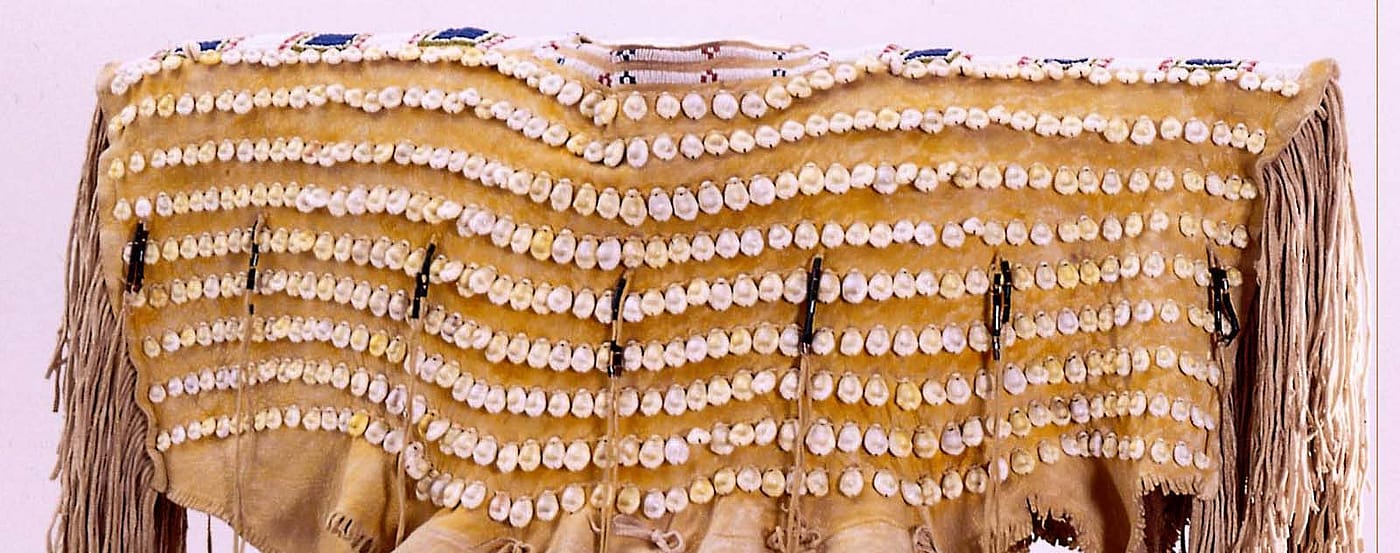 Cheyenne dress with cowrie shell adornment. Chandler-Pohrt Collection, Gift of Mr. William D. Weiss. NA.202.446 (detail)