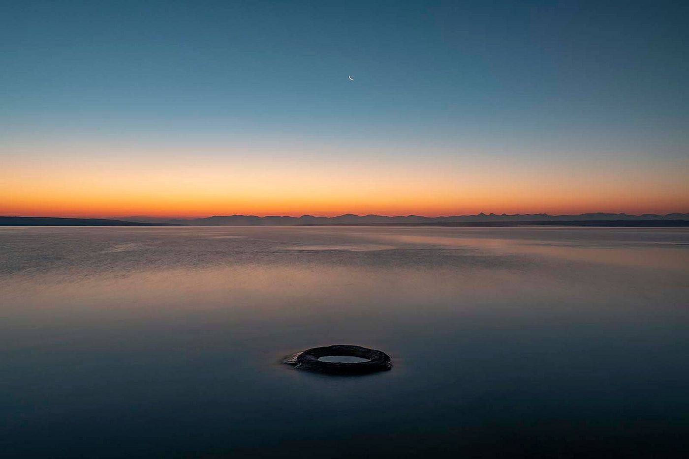 “Fishing Cone.” Fishing cone hot spring, in the West thumb area of Yellowstone Lake, was once a geyser with eruptions as high as 40 feet. As water levels have risen in the lake, the once-active geyser has now fallen silent. What Lies Beneath: Exploring Yellowstone Lake’s Mysterious Vents / Photographs by Chris Linder, Woods Hole Oceanographic Institution.
