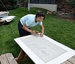 2013 Conservation Intern Josefina Moldonado cleans blueprints from the Cody Firearms Museum