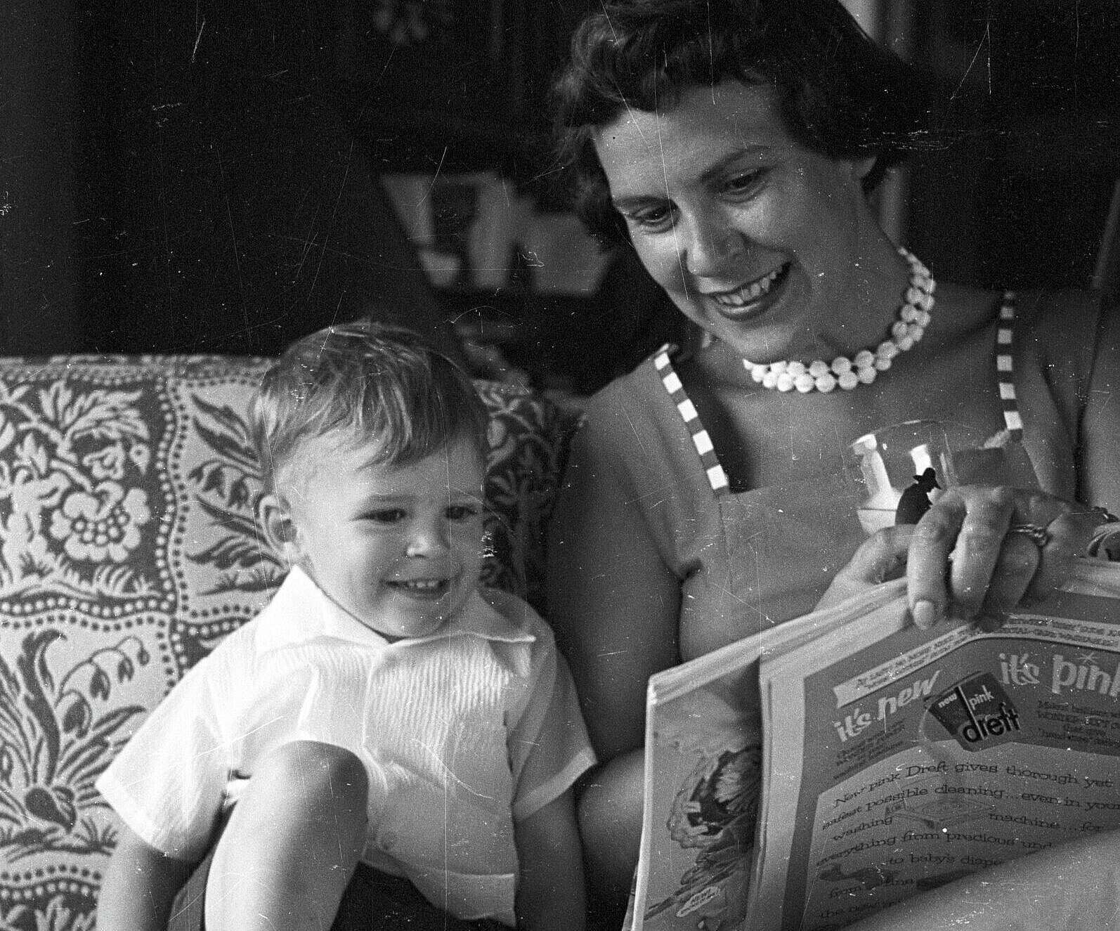 Sam Allen & family, June 26, 1955; Jerri and Sammy sitting on a couch reading a book