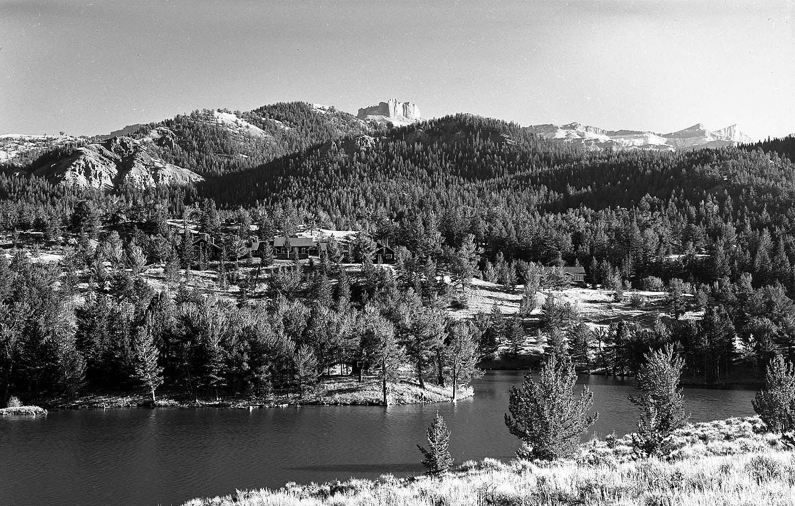 Coe Lodge complex, looking south from the far side of Irma Lake; pinnacles of Carter mountain on horizon