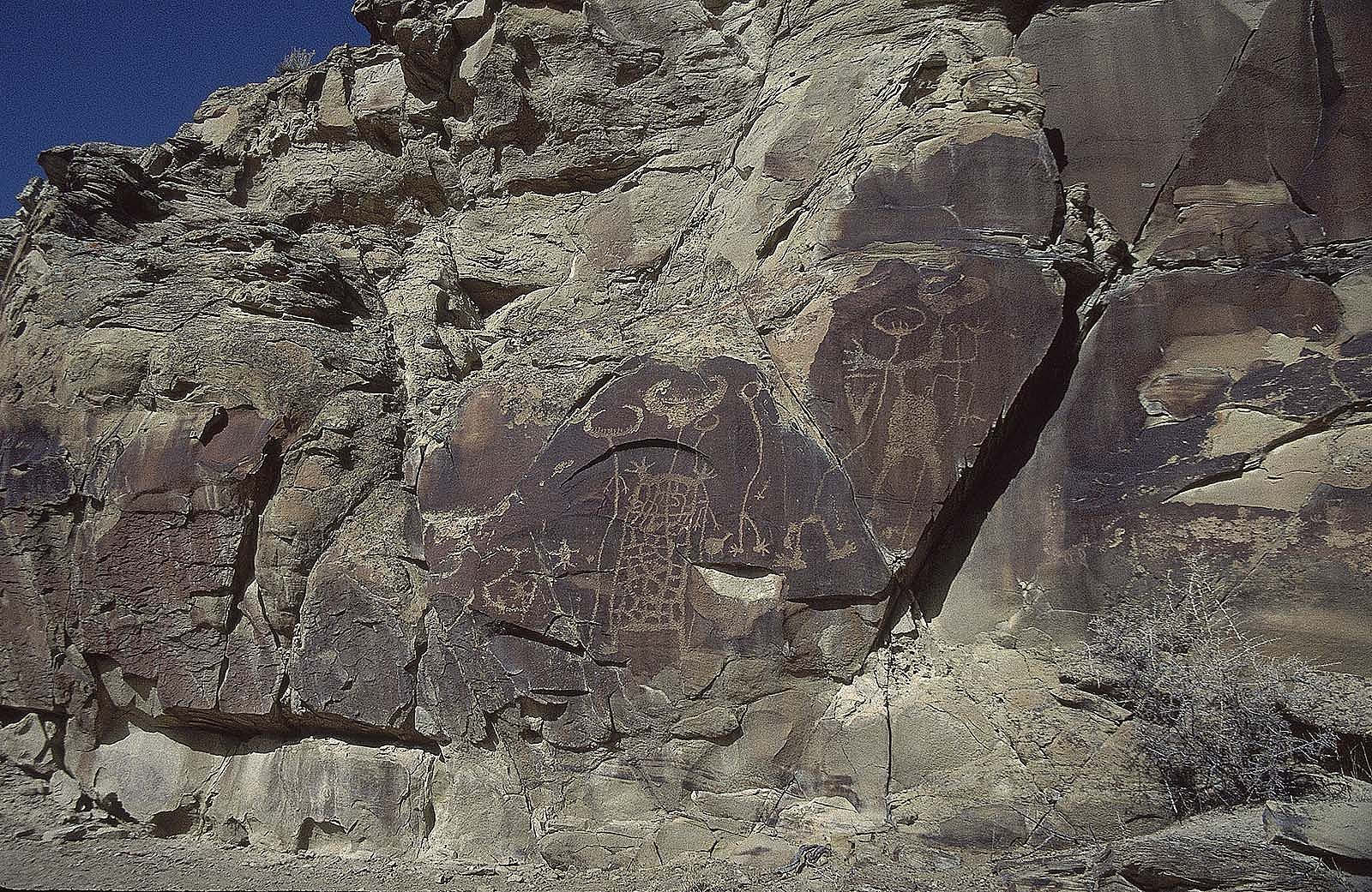 Petroglyphs on rock face at Legend Rock. MS 301 Gabby Barrus Slide Collection, McCracken Research Library. SL.301.24.232