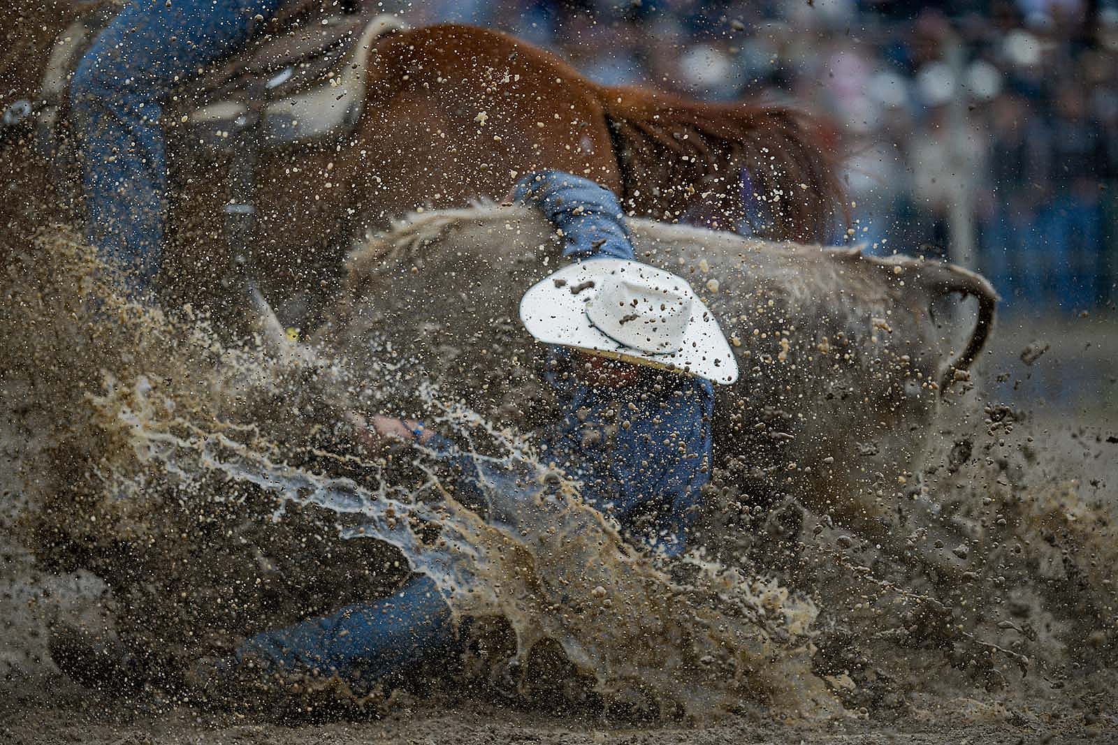 Team roping in the mud. Photo by Christopher "Click" Thompson.