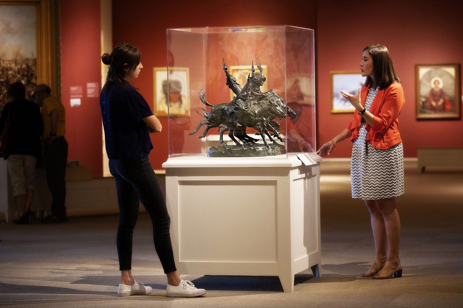 Examining Frederic Remington's Coming through the Rye, Whitney Western Art Museum, Buffalo Bill Center of the West, Cody, Wyoming, USA. (Frederic Remington bronze, Coming Through the Rye. Gift of Barbara S. Leggett. 5.66) (BBCW-WWAM02)