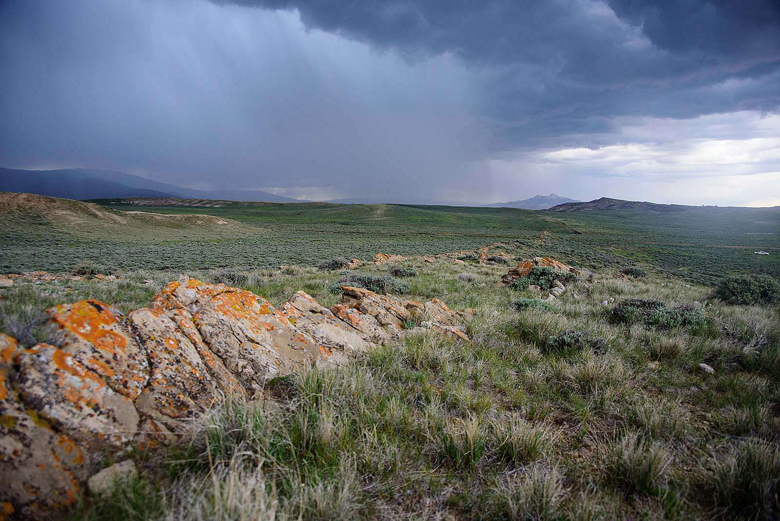 Rain clouds with Heart Mountain in distance. Moosejaw Bravo Photography.