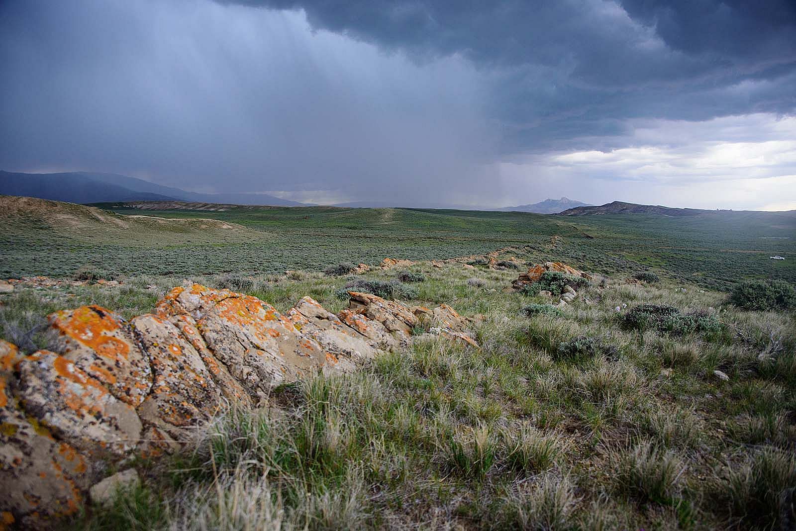 Rain clouds with Heart Mountain in distance. Moosejaw Bravo Photography.